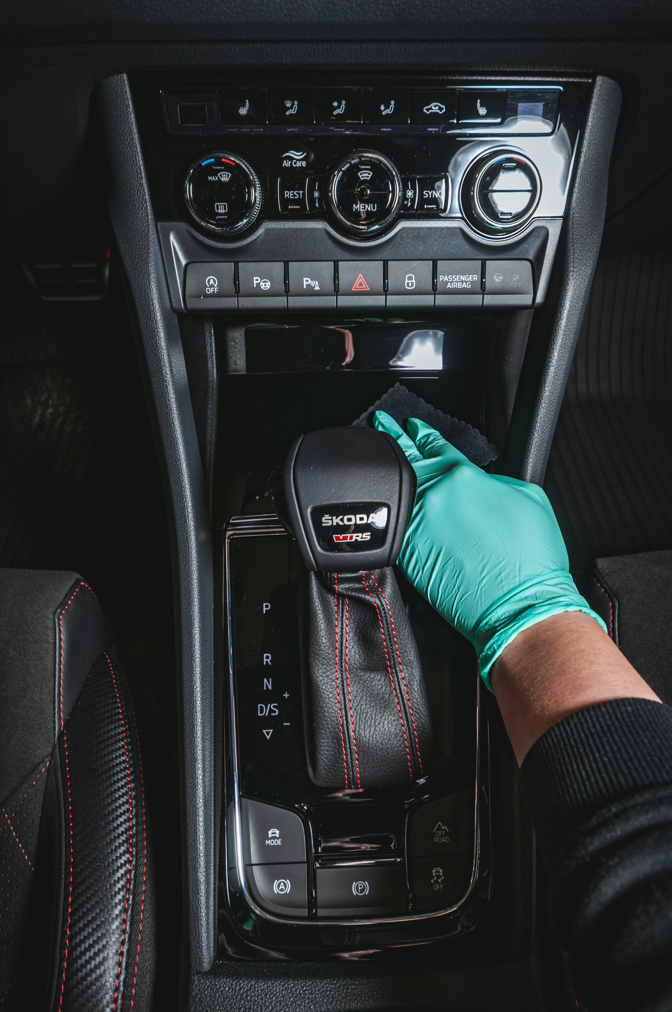 Detailer wiping dashboard during interior detail