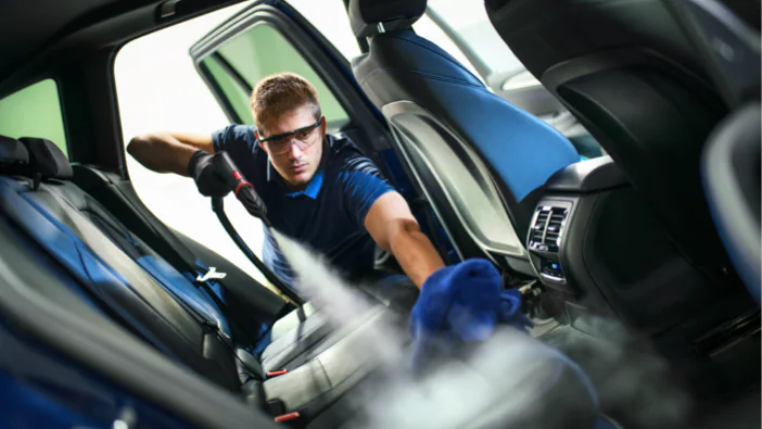 Steam cleaning vehicle interior surfaces